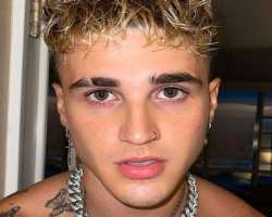 He has a piercing in the nose and ear.